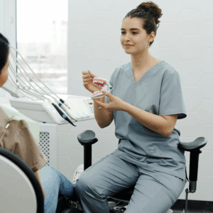 dental staff pointing at teeth mold