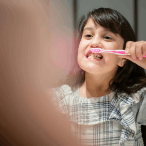 little girl brushing teeth