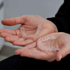 clear aligners on hands